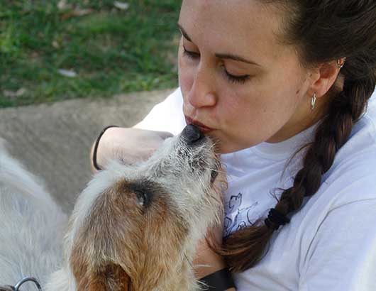 Woman getting doggy kisses